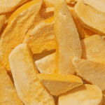 Close-up of freeze-dried mango slices in a heap.