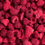 Close-up of freeze-dried raspberries with a vibrant red color.